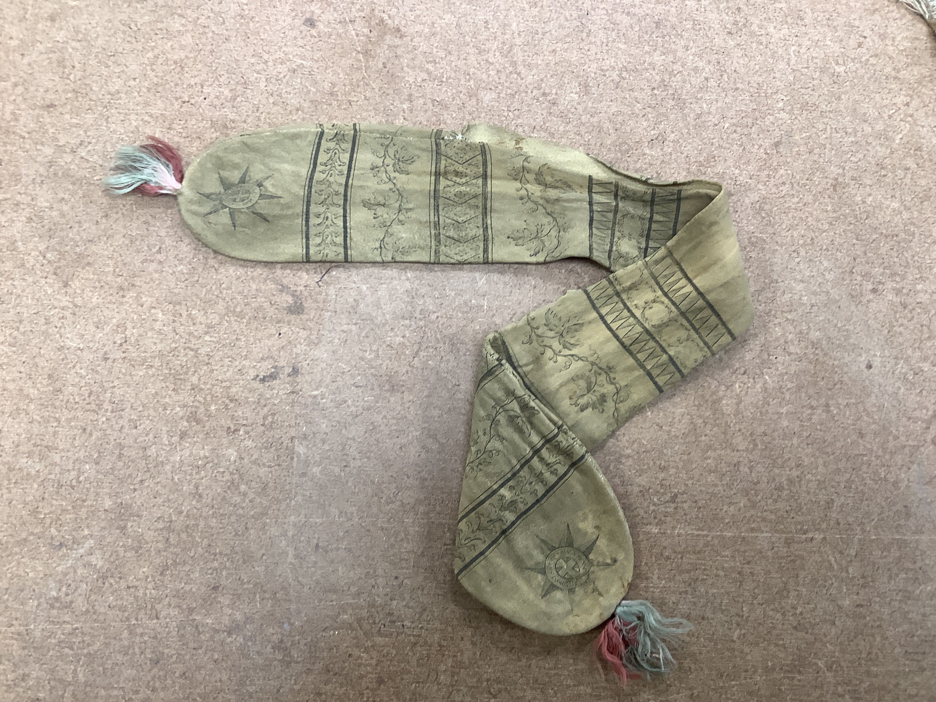An 18th century American leather misers purse dated 1793, an unused finely woven tapestry, an early 19th century bead worked misers purse, longest misers purse 48cm